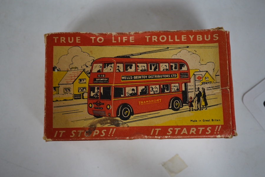 A boxed Wells Brimtoy tinplate clockwork trolley bus loosely in London Transport livery, together with three keys. Condition fair to good, clockwork motor appears to work correctly although has lost grip on the driving a